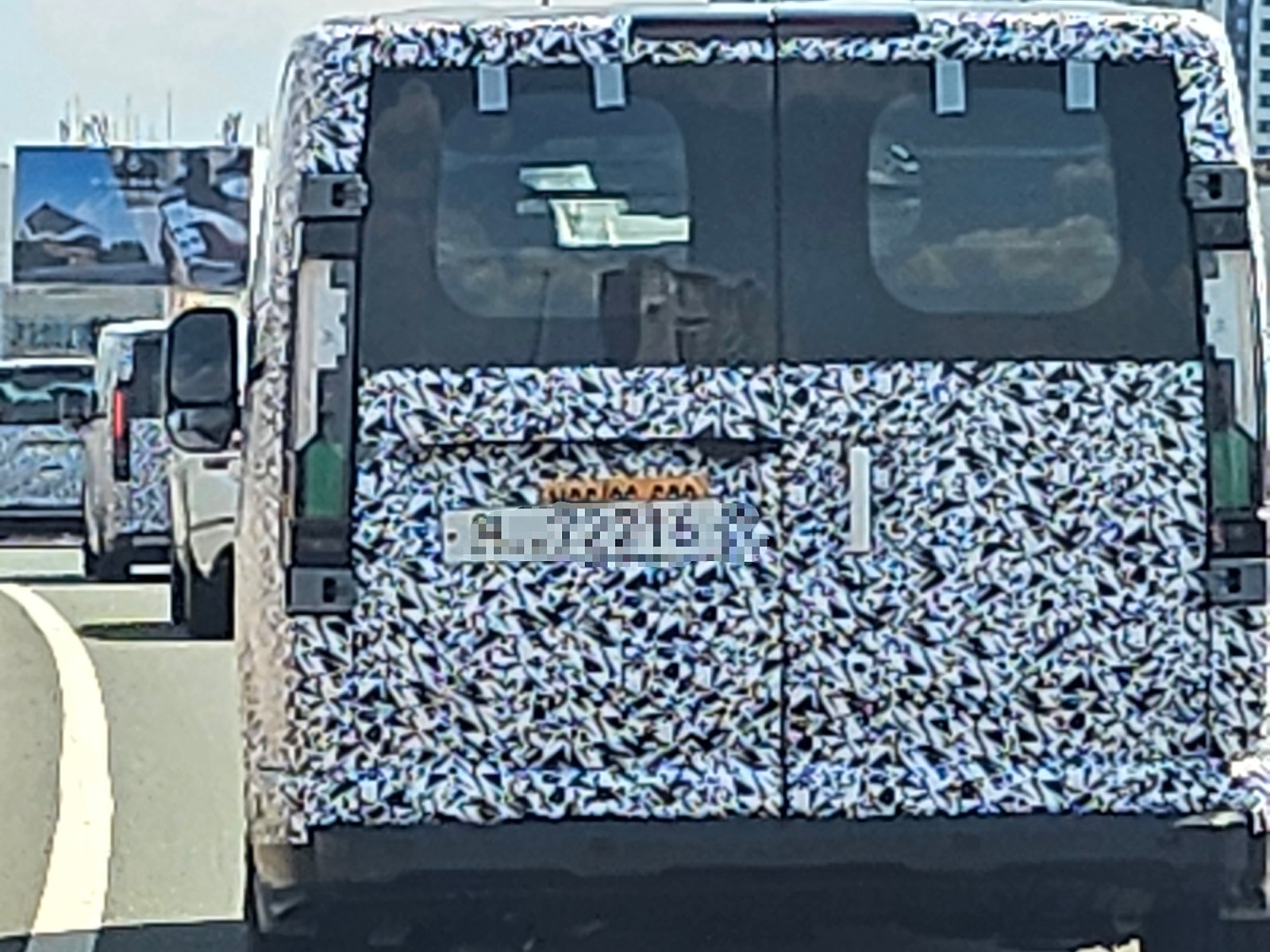 Kia’s larger electric van caught with less camo ahead of its ‘big’ debut [Images]