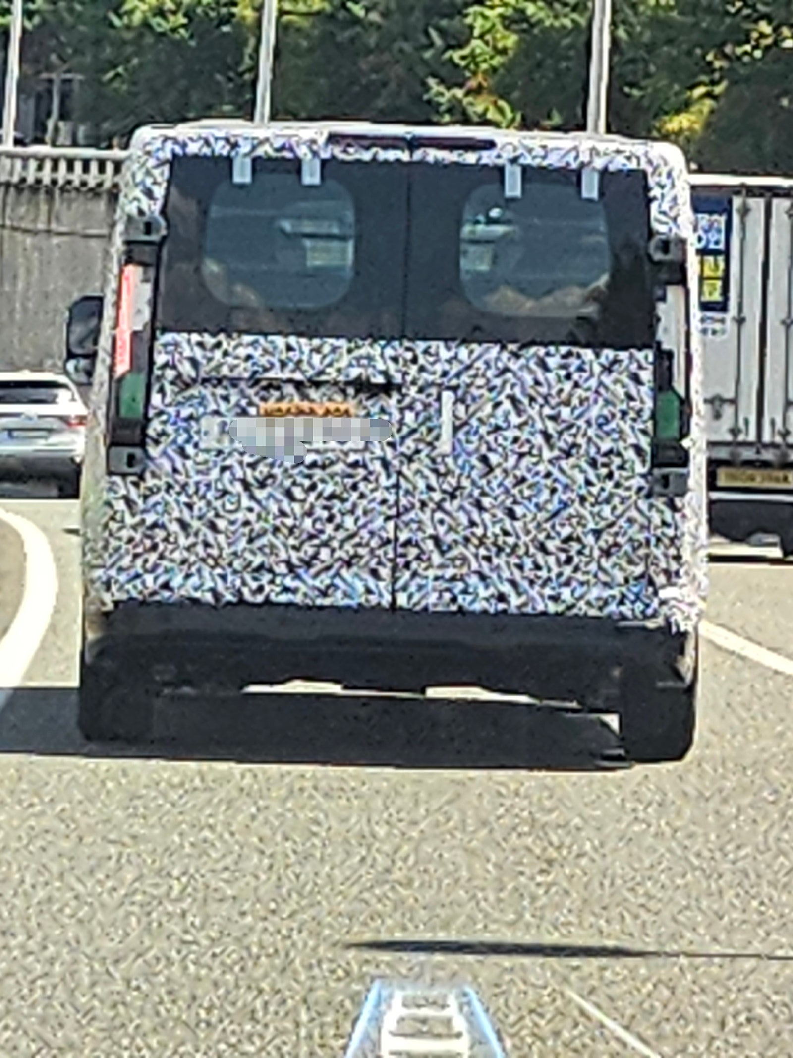 Kia’s larger electric van caught with less camo ahead of its ‘big’ debut [Images]